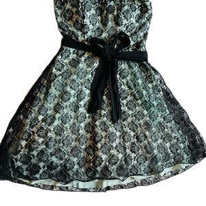 Short black lace dress with mint green trim and bow belt